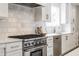 Modern kitchen featuring stainless steel range, white cabinets, and subway tile backsplash for a sleek and clean design at 8001 N Illinois St, Indianapolis, IN 46260
