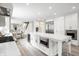 Spacious all-white kitchen features a large island, modern appliances, and seamless access to the dining and living areas at 8001 N Illinois St, Indianapolis, IN 46260