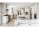 Open kitchen with stainless steel appliances, a large center island, and a view into the adjacent living area at 8001 N Illinois St, Indianapolis, IN 46260