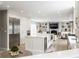 Open-concept kitchen with large island, stainless steel appliances, and seamless flow to living area at 8001 N Illinois St, Indianapolis, IN 46260