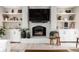 Elegant living room with a brick fireplace, built-in shelving, and cozy seating creating a warm and inviting atmosphere at 8001 N Illinois St, Indianapolis, IN 46260