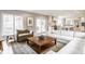 Sunlit living area with a large window, modern furnishings, and an open layout connecting to the kitchen and dining spaces at 8001 N Illinois St, Indianapolis, IN 46260