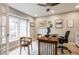 Bright office with wood desk, natural light, ceiling fan, and neutral color palette at 8001 N Illinois St, Indianapolis, IN 46260