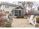 Backyard brick patio with outdoor seating and a view of the screen porch at 8001 N Illinois St, Indianapolis, IN 46260