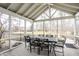 Screened-in patio with a dining table and seating, overlooking the backyard at 8001 N Illinois St, Indianapolis, IN 46260
