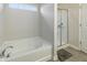 Bright bathroom featuring a soaking tub with window and separate shower with glass enclosure at 8193 Cagles Mill Trce, Avon, IN 46123