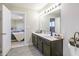 Bathroom with dual vanity, framed mirror and access to primary bedroom at 8193 Cagles Mill Trce, Avon, IN 46123
