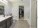Primary bathroom with double sink vanity, soaking tub and open access to the walk-in closet at 8193 Cagles Mill Trce, Avon, IN 46123