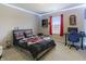 Bedroom featuring a bed with decorative pillows, a desk and a window with red curtains at 8193 Cagles Mill Trce, Avon, IN 46123