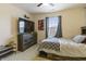 Bedroom featuring a bed with drawers, a TV, dresser and a window with curtains at 8193 Cagles Mill Trce, Avon, IN 46123