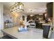 Eat-in kitchen showcases an island, open to living areas, pendant lighting, and dark cabinetry at 8193 Cagles Mill Trce, Avon, IN 46123