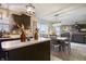 Bright eat-in kitchen features dark cabinetry, modern lighting, eat in area and backyard access at 8193 Cagles Mill Trce, Avon, IN 46123