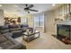 Comfortable living room with fireplace, ceiling fan, and backyard view at 8193 Cagles Mill Trce, Avon, IN 46123
