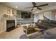 Comfortable living room featuring a fireplace, ceiling fan, large TV and plush sofa at 8193 Cagles Mill Trce, Avon, IN 46123