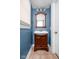 Cozy bathroom with a wood vanity and bright blue walls at 825 N Bancroft St, Indianapolis, IN 46201