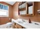 This bathroom features a modern vanity with a sink and framed mirror at 825 N Bancroft St, Indianapolis, IN 46201