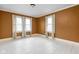A bedroom featuring blank canvas, white trim, wood floors, and multiple windows at 825 N Bancroft St, Indianapolis, IN 46201