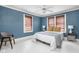 Comfortable bedroom with light blue walls, and two windows with wood blinds at 825 N Bancroft St, Indianapolis, IN 46201