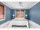 This bedroom features bright walls, and two windows with light streaming through at 825 N Bancroft St, Indianapolis, IN 46201