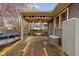 A covered deck that's perfect for relaxation or entertainment. Above ground pool in view at 825 N Bancroft St, Indianapolis, IN 46201
