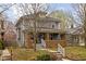 View of a well-maintained two-story home with a welcoming porch at 825 N Bancroft St, Indianapolis, IN 46201