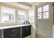 A laundry room with clean white counters, dark cabinets, and a convenient exterior door at 825 N Bancroft St, Indianapolis, IN 46201