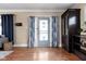 Bright, airy living room with hardwood floors, decorative cabinets, and stylish curtains at 825 N Bancroft St, Indianapolis, IN 46201