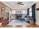 Elegant living room boasting hardwood floors, a cozy fireplace, and large windows at 825 N Bancroft St, Indianapolis, IN 46201