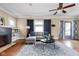 Bright living room featuring a gray sofa, a ceiling fan, and beautiful hardwood floors at 825 N Bancroft St, Indianapolis, IN 46201