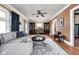 Inviting living room with a comfortable gray sofa, area rug, and natural light at 825 N Bancroft St, Indianapolis, IN 46201