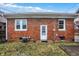 Backyard view of brick home with a small lawn and patio area, perfect for outdoor activities at 959 E Bradbury Ave, Indianapolis, IN 46203