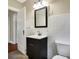 Bathroom featuring a dark vanity with a mirror and white tiled walls at 959 E Bradbury Ave, Indianapolis, IN 46203