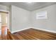 Cozy bedroom with hardwood floors and natural light from the window at 959 E Bradbury Ave, Indianapolis, IN 46203