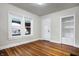 Bright bedroom with hardwood floors, built-in shelving, and large windows providing natural light at 959 E Bradbury Ave, Indianapolis, IN 46203