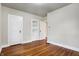 Bedroom featuring hardwood floors, neutral walls, and built-in shelving at 959 E Bradbury Ave, Indianapolis, IN 46203