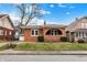 Charming brick home featuring a cozy front porch, complemented by manicured landscaping and a well-maintained lawn at 959 E Bradbury Ave, Indianapolis, IN 46203