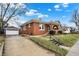 Charming brick home featuring a cozy front porch, complemented by manicured landscaping and a detached garage at 959 E Bradbury Ave, Indianapolis, IN 46203