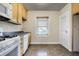 Well-lit kitchen featuring neutral cabinets, laminate flooring, and window for natural light at 959 E Bradbury Ave, Indianapolis, IN 46203