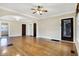 Spacious living room boasting gleaming hardwood floors, neutral paint, archways, and abundant natural light at 959 E Bradbury Ave, Indianapolis, IN 46203