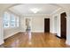 Inviting living room boasts hardwood floors, natural light, and arched doorway at 959 E Bradbury Ave, Indianapolis, IN 46203