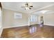 Open-concept living room with hardwood floors, ceiling fan and natural light from many windows at 959 E Bradbury Ave, Indianapolis, IN 46203