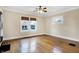 Bright living room features hardwood floors, a ceiling fan, and natural light from two windows at 959 E Bradbury Ave, Indianapolis, IN 46203