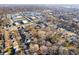 Overhead view of a neighborhood showcasing homes, tree-lined streets, and nearby commercial areas at 1020 E 51St St, Indianapolis, IN 46205