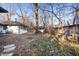 Overgrown backyard with fencing and mature trees at 1020 E 51St St, Indianapolis, IN 46205