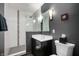 Well-lit bathroom with dark walls, white shower, and modern vanity at 1020 E 51St St, Indianapolis, IN 46205