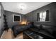 Stylish bedroom with dark walls, a comfortable bed, leather sofa, and modern decor, offering a sleek retreat at 1020 E 51St St, Indianapolis, IN 46205