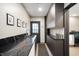 A modern kitchen with dark countertops, cabinetry, and stainless steel appliances at 1020 E 51St St, Indianapolis, IN 46205