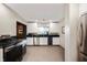 Bright and modern kitchen with white cabinetry, dark countertops and stainless steel appliances at 1020 E 51St St, Indianapolis, IN 46205