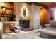 Charming living room features a unique stone fireplace, wooden accents, and cozy seating, ideal for gatherings at 1020 E 51St St, Indianapolis, IN 46205