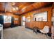 Bright living room with wood paneling, neutral carpet, and ample natural light, offers a warm and inviting space at 1020 E 51St St, Indianapolis, IN 46205